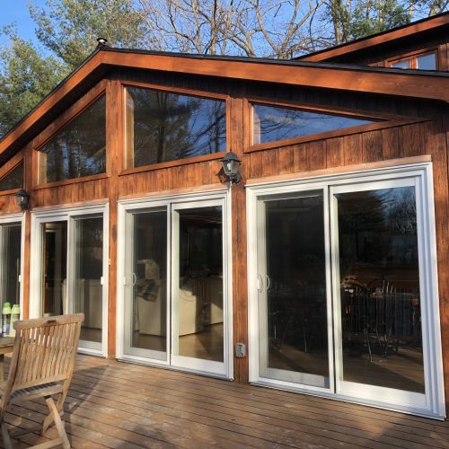 Home exterior with sliding glass doors opening onto a deck