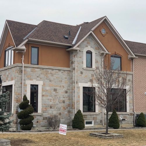 Stone and brick house with large windows