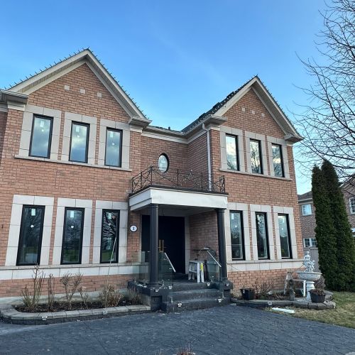 Brick house with a porch and large new windows