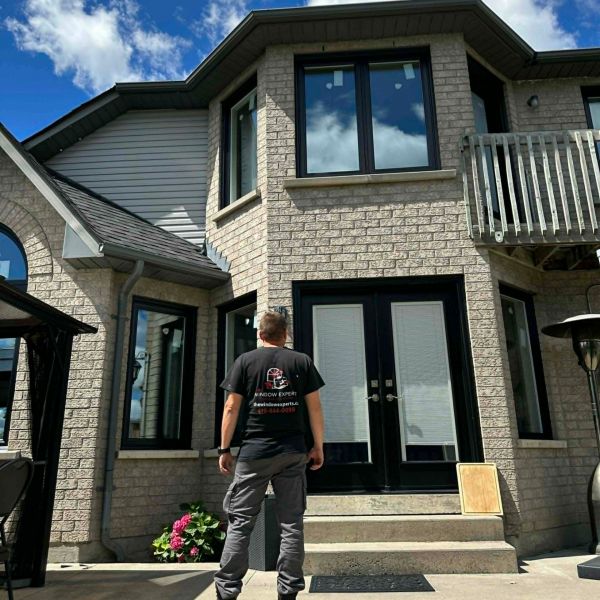 Window Experts crew installing windows on a home exterior