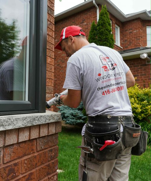 Certified installer working on a window frame