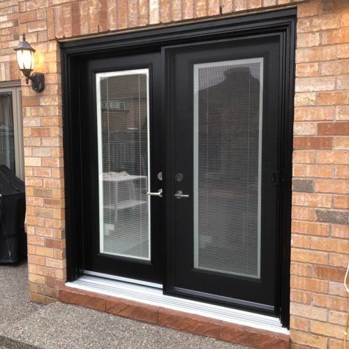 Black double doors on a modern home exterior