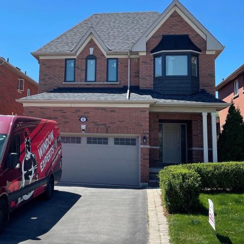 Window Experts van parked in front of a home garage